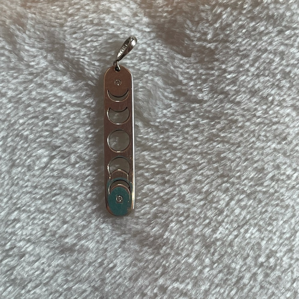White gold moon phase cut-out pendant with tiny diamond accents